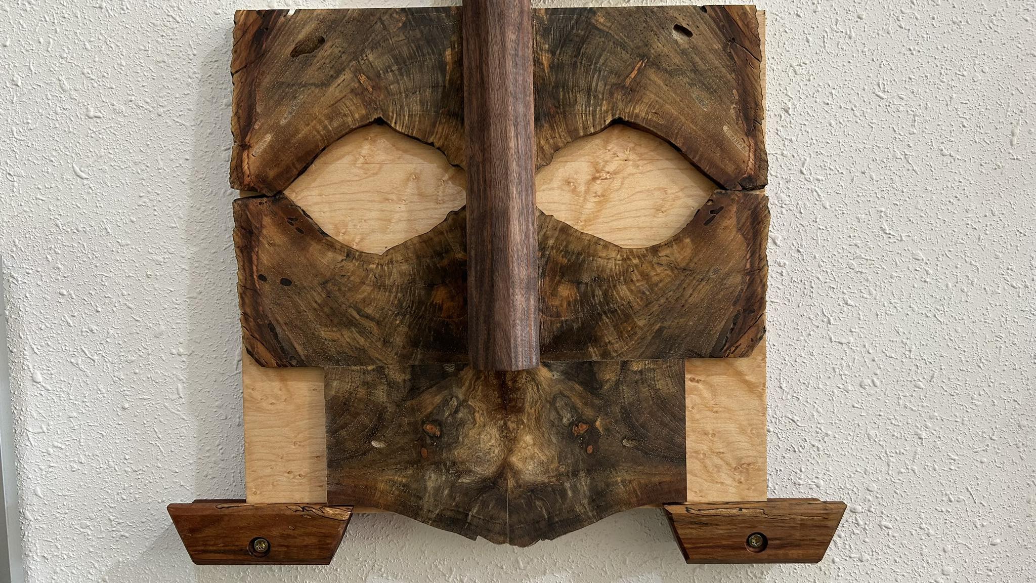 Carved face from figured burl wood