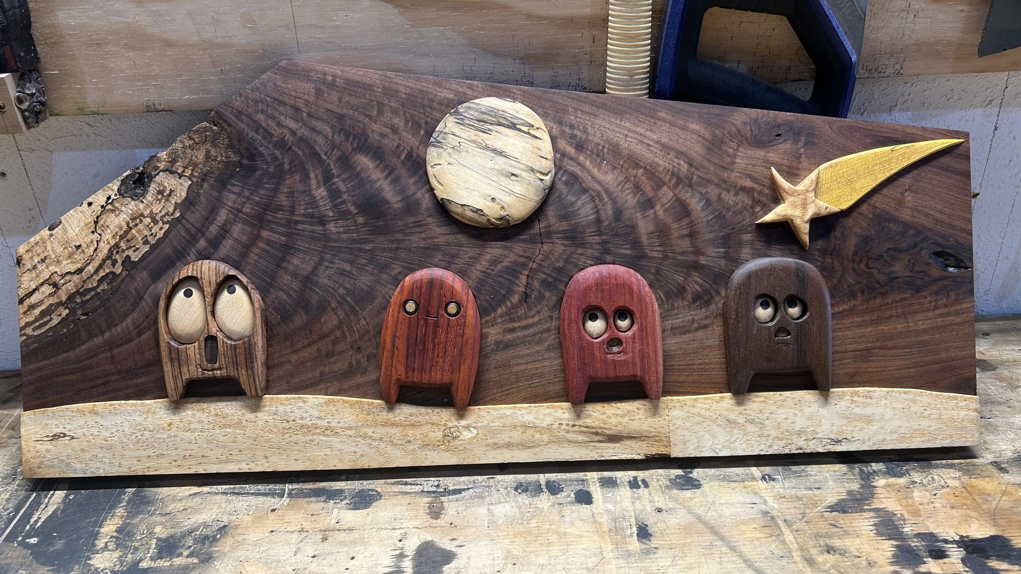 Original carved wood art: small wood creatures on live-edge walnut under a spalted-wood moon and gold shooting star